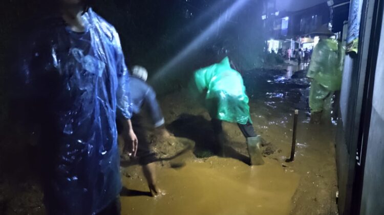 Warga tengah membersihkan lumpur yang menutupi jalan di Kampung Jemprak, Desa Ciloto, Kecamatan Cipanas, Sabtu (5/7/2025). (Foto : Ario/cianjurtimes.com)